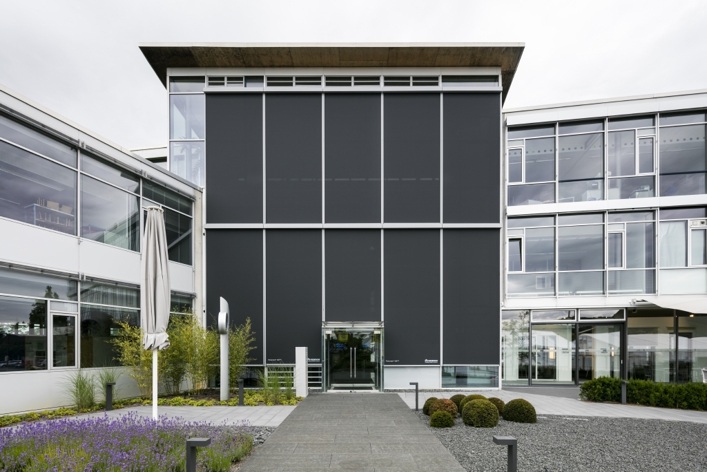Facade of building with external screens on all windows