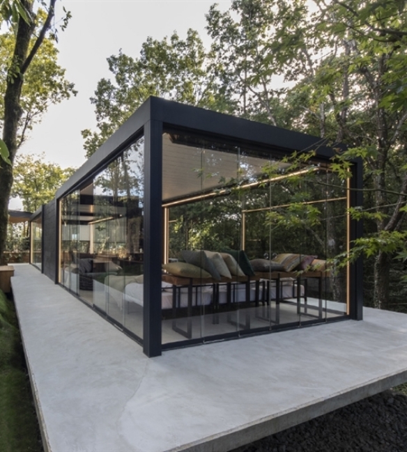 Black aluminum free standing louvered roof pergola enclosed with glass panel sliding doors