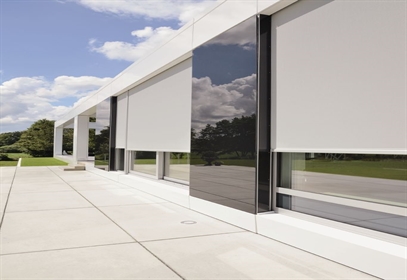 grey external roller blinds installed on the outside of a window of home