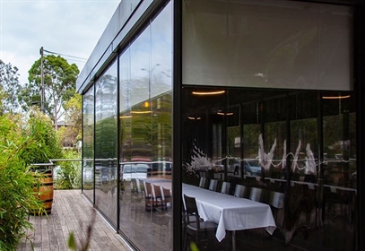 Clear PVC vinyl blinds enclosing a covered patio space