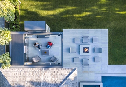 Retracting Louvers Louvered pergola adjacent to the side of a home with retracted louvers